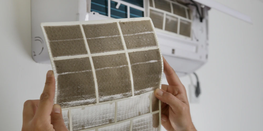 Clogged aircon drainage pipe with dirt buildup causing water leakage