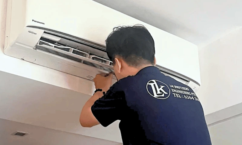 Professional LK Brothers specialist diagnosing aircon noise problem