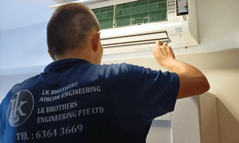 LK Brothers technician performing regular aircon servicing in Singapore